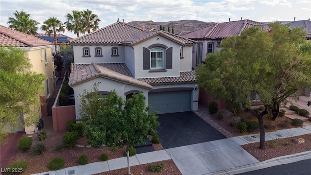 11731 Longworth Rd, Las Vegas, NV 89135 - mediterranean / spanish home featuring stucco siding, a tiled roof, a garage, and concrete driveway
