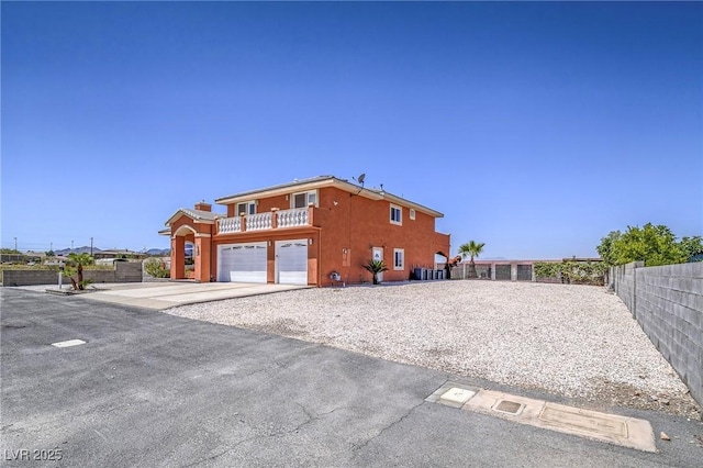 420 Dakar St, Henderson, NV 89015 - view of property exterior featuring concrete driveway, an attached garage, stucco siding, and a balcony