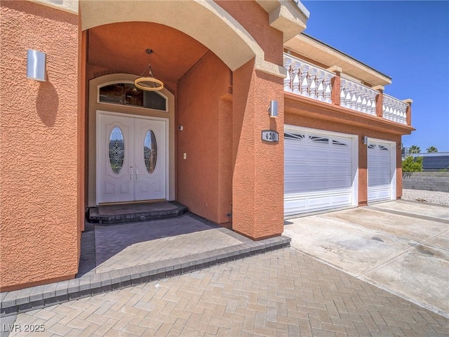 420 Dakar St, Henderson, NV 89015 - view of exterior entry featuring stucco siding, driveway, and an attached garage