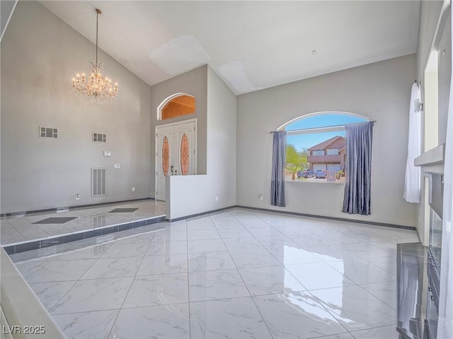 420 Dakar St, Henderson, NV 89015 - foyer with light marble finish floors, a chandelier, a towering ceiling, and baseboards