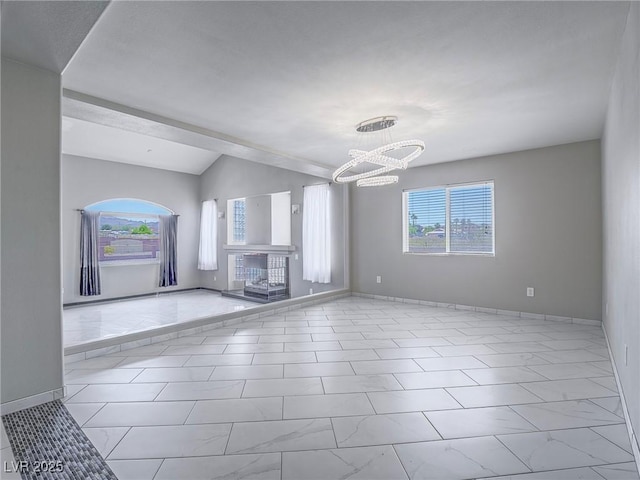 420 Dakar St, Henderson, NV 89015 - unfurnished living room with a chandelier, plenty of natural light, lofted ceiling, and baseboards
