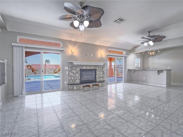 420 Dakar St, Henderson, NV 89015 - unfurnished living room featuring a ceiling fan, baseboards, a stone fireplace, and lofted ceiling