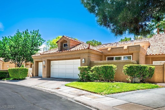 8236 Round Hills Cir, Las Vegas, NV 89113 - mediterranean / spanish house featuring a tile roof, stucco siding, a garage, and concrete driveway