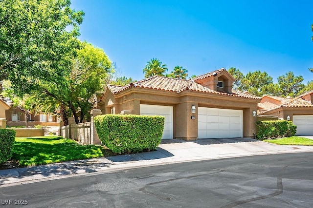 8236 Round Hills Cir, Las Vegas, NV 89113 - mediterranean / spanish-style home featuring a tile roof, stucco siding, and a garage