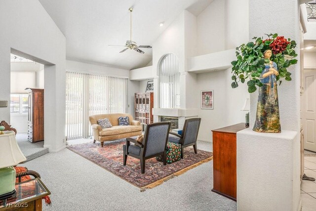 8236 Round Hills Cir, Las Vegas, NV 89113 - living area featuring ceiling fan, carpet flooring, high vaulted ceiling, and a fireplace