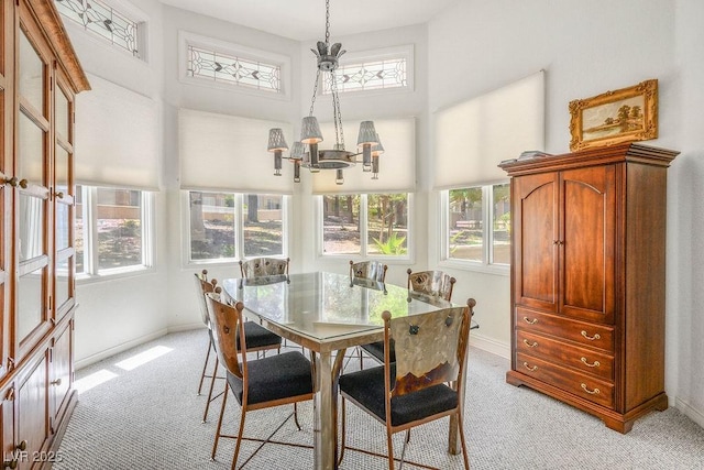 8236 Round Hills Cir, Las Vegas, NV 89113 - dining room with light carpet, a chandelier, plenty of natural light, baseboards, and a high ceiling