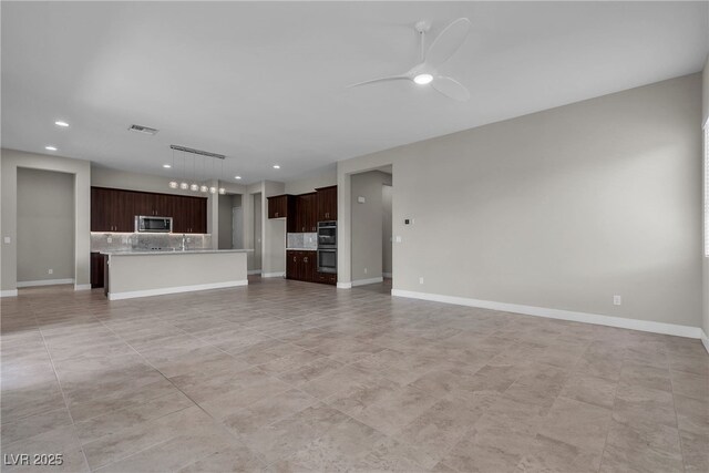 4829 E Beacon Ridge Dr, Pahrump, NV 89061 - unfurnished living room with ceiling fan, recessed lighting, baseboards, a sink, and light tile patterned flooring