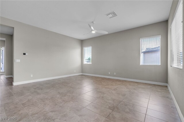 4829 E Beacon Ridge Dr, Pahrump, NV 89061 - empty room with plenty of natural light, light tile patterned floors, and a ceiling fan