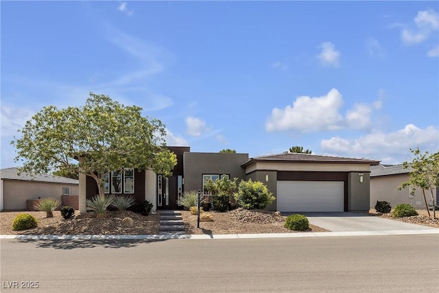 4829 E Beacon Ridge Dr, Pahrump, NV 89061 - view of front of home with an attached garage, driveway, and stucco siding