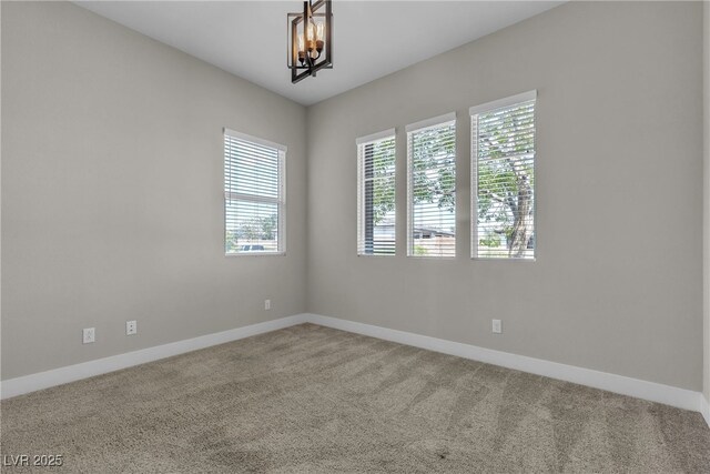 4829 E Beacon Ridge Dr, Pahrump, NV 89061 - spare room with plenty of natural light, a chandelier, and carpet floors
