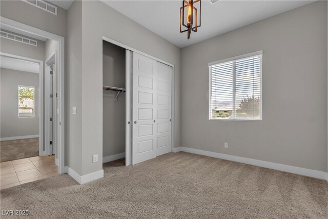 4829 E Beacon Ridge Dr, Pahrump, NV 89061 - unfurnished bedroom featuring carpet flooring, a closet, baseboards, and a chandelier