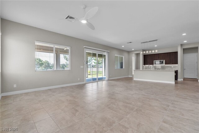 4829 E Beacon Ridge Dr, Pahrump, NV 89061 - unfurnished living room with ceiling fan, light tile patterned flooring, recessed lighting, a sink, and baseboards