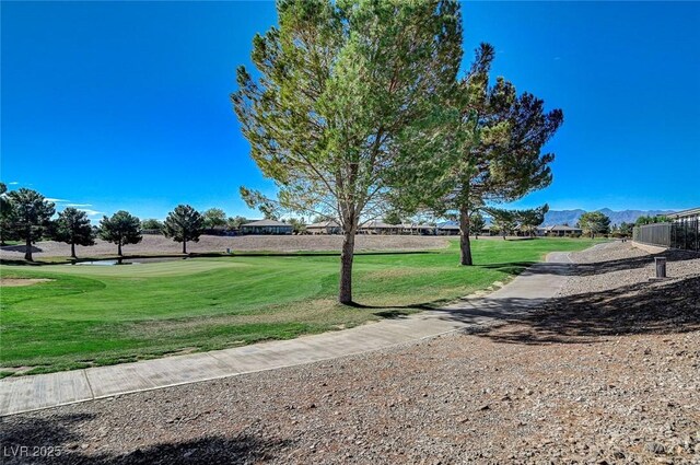 4829 E Beacon Ridge Dr, Pahrump, NV 89061 - view of property's community with a mountain view, a yard, and view of golf course