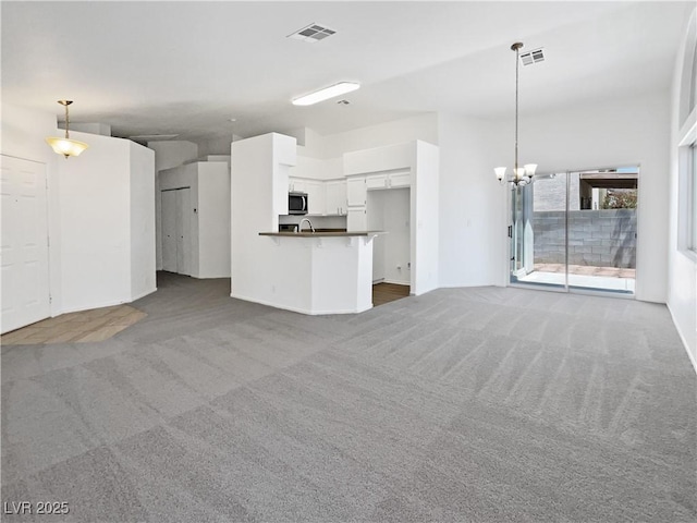 7524 Fencerow St, Las Vegas, NV 89131 - unfurnished living room featuring carpet and a chandelier