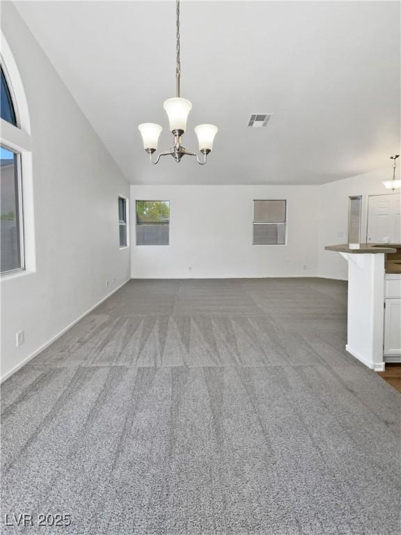 7524 Fencerow St, Las Vegas, NV 89131 - unfurnished living room featuring a chandelier, carpet, and baseboards