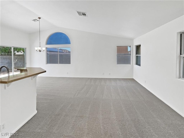 7524 Fencerow St, Las Vegas, NV 89131 - unfurnished living room featuring lofted ceiling, carpet flooring, a chandelier, baseboards, and a sink
