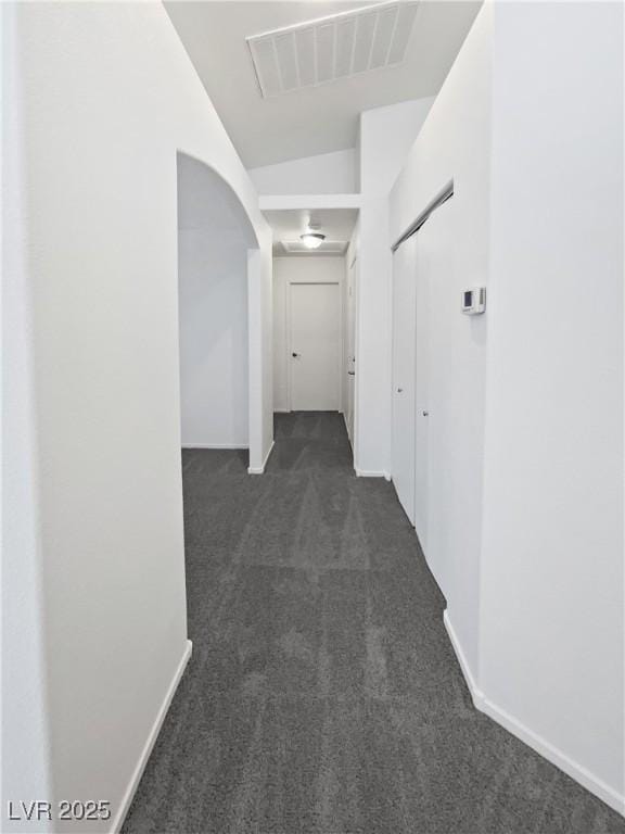 7524 Fencerow St, Las Vegas, NV 89131 - hall featuring dark carpet, arched walkways, and baseboards