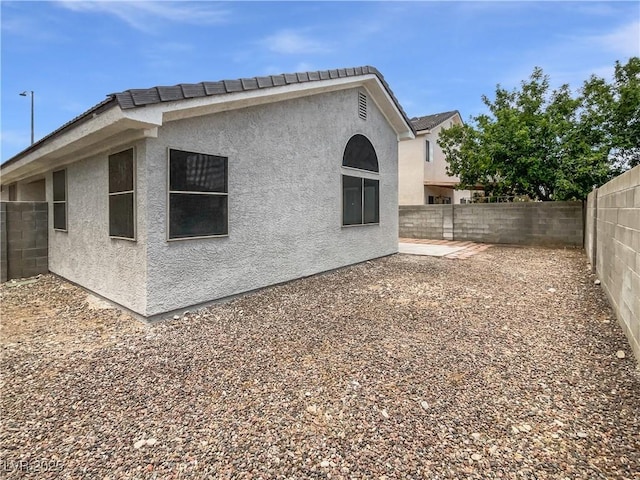 7524 Fencerow St, Las Vegas, NV 89131 - view of side of home with stucco siding and a fenced backyard