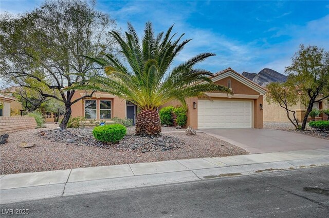 2353 Lauren Dr, Las Vegas, NV 89134 - view of property hidden behind natural elements featuring a garage, stucco siding, and concrete driveway
