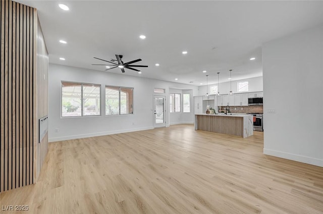 2353 Lauren Dr, Las Vegas, NV 89134 - unfurnished living room with recessed lighting, healthy amount of natural light, light wood-style flooring, and a ceiling fan