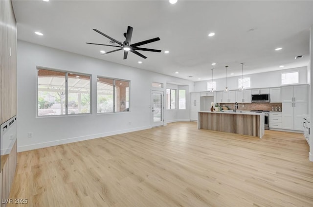2353 Lauren Dr, Las Vegas, NV 89134 - unfurnished living room with recessed lighting, ceiling fan, and light wood finished floors