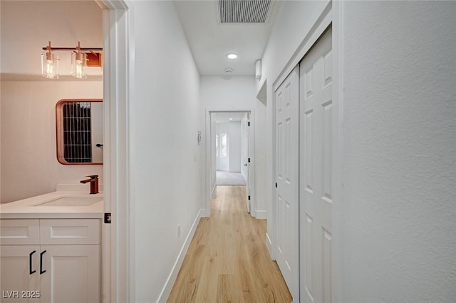 2353 Lauren Dr, Las Vegas, NV 89134 - hallway featuring a sink and light wood-style flooring