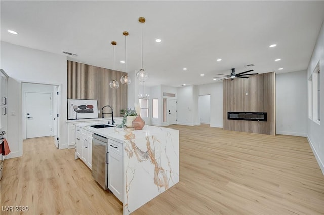 2353 Lauren Dr, Las Vegas, NV 89134 - kitchen featuring stainless steel dishwasher, light wood-style flooring, an island with sink, ceiling fan, and recessed lighting