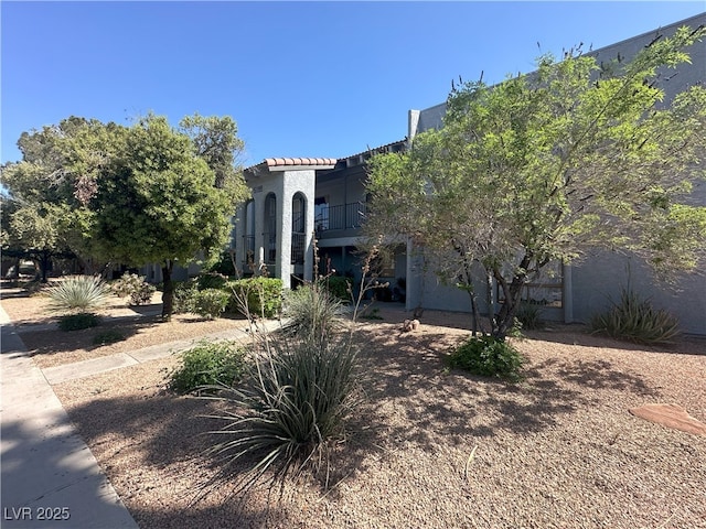 5199 Caliente St Unit 64, Las Vegas, NV 89119 - view of front of house with stucco siding and a balcony