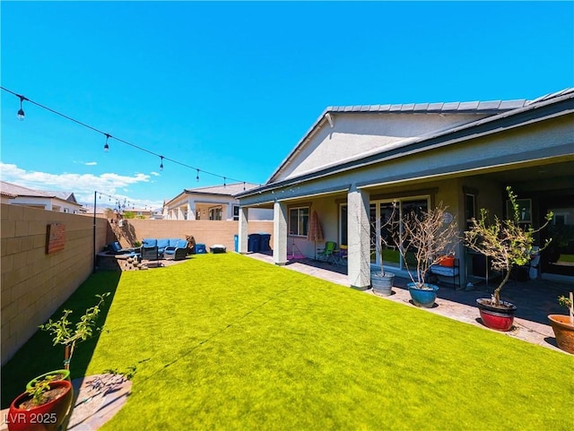 6021 Vivanco St, North Las Vegas, NV 89081 - fenced backyard with a patio area and outdoor lounge area