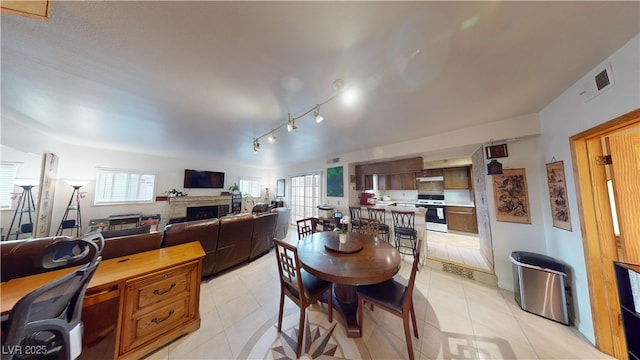4998 Schumann Dr, Las Vegas, NV 89146 - dining space with a fireplace and light tile patterned floors