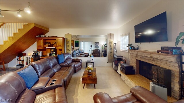 4998 Schumann Dr, Las Vegas, NV 89146 - living area featuring stairway, a fireplace, and light tile patterned flooring