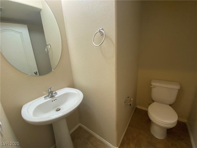 10537 Thor Mountain Ln, Las Vegas, NV 89166 - bathroom with toilet, tile patterned flooring, and baseboards