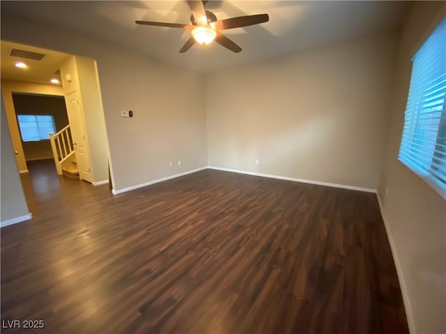 10537 Thor Mountain Ln, Las Vegas, NV 89166 - unfurnished room with dark wood-type flooring, a ceiling fan, and baseboards