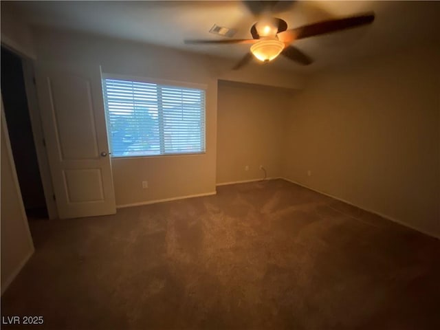 10537 Thor Mountain Ln, Las Vegas, NV 89166 - empty room with ceiling fan, dark carpet, and baseboards