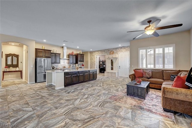 7331 Abundant Harvest Ave, Las Vegas, NV 89131 - living area with arched walkways, a ceiling fan, and recessed lighting