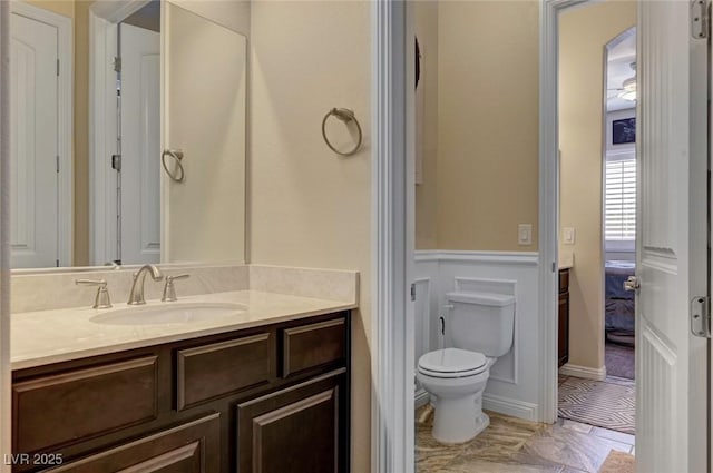 7331 Abundant Harvest Ave, Las Vegas, NV 89131 - bathroom featuring vanity, toilet, and a wainscoted wall