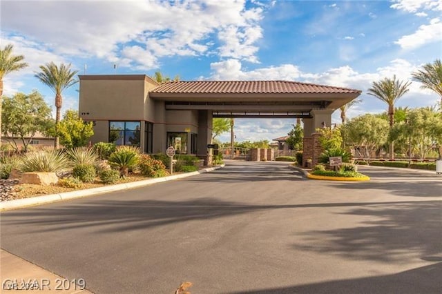 7332 Redhead Dr, North Las Vegas, NV 89084 - view of asphalt street with a gated entry, curbs, and a gate