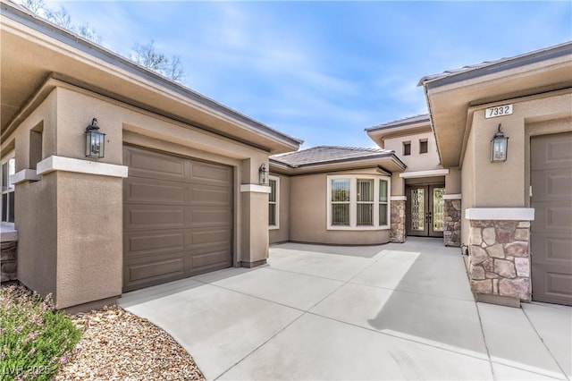 7332 Redhead Dr, North Las Vegas, NV 89084 - garage featuring french doors and driveway