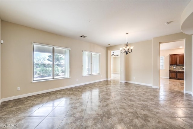 7332 Redhead Dr, North Las Vegas, NV 89084 - empty room featuring a chandelier and light tile patterned floors