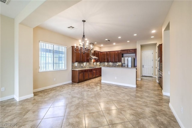 7332 Redhead Dr, North Las Vegas, NV 89084 - kitchen featuring stainless steel appliances, a chandelier, recessed lighting, a kitchen island, and backsplash