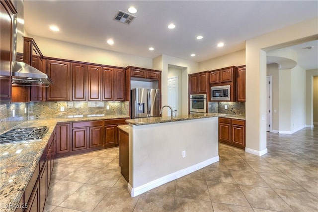 7332 Redhead Dr, North Las Vegas, NV 89084 - kitchen with appliances with stainless steel finishes, tasteful backsplash, light tile patterned floors, wall chimney exhaust hood, and light stone counters
