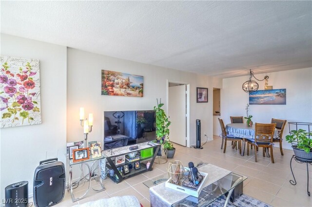 3930 University Center Dr Unit 706, Las Vegas, NV 89119 - tiled living area with a chandelier and a textured ceiling