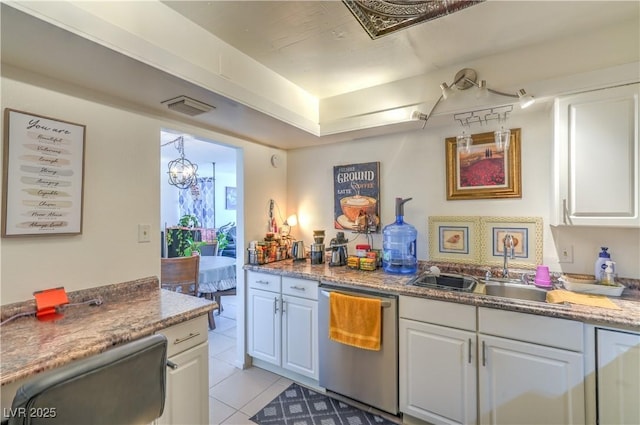 3930 University Center Dr Unit 706, Las Vegas, NV 89119 - kitchen featuring stainless steel dishwasher, a sink, white cabinetry, light tile patterned floors, and a chandelier