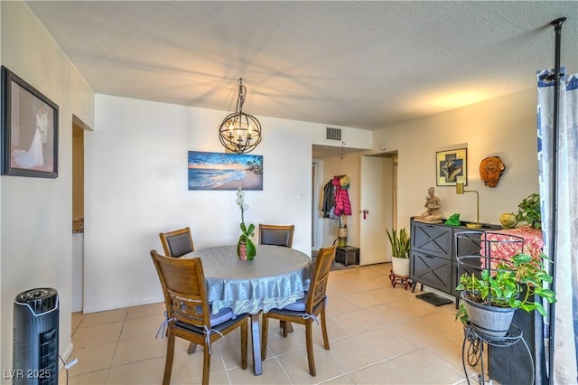 3930 University Center Dr Unit 706, Las Vegas, NV 89119 - dining space featuring light tile patterned floors, a chandelier, and a textured ceiling