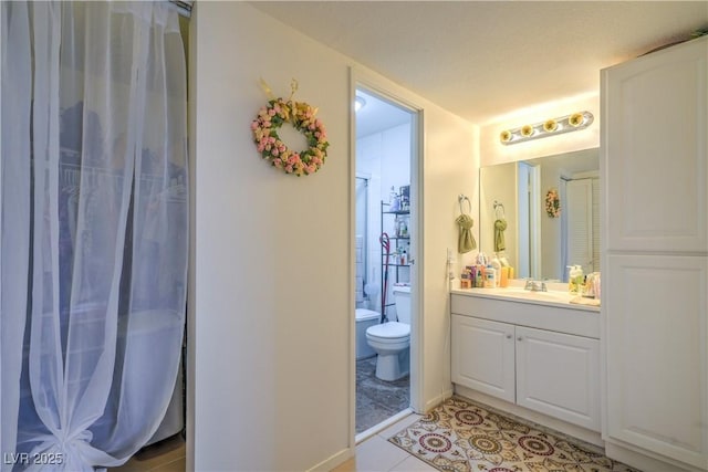 3930 University Center Dr Unit 706, Las Vegas, NV 89119 - bathroom featuring toilet, vanity, curtained shower, and tile patterned flooring