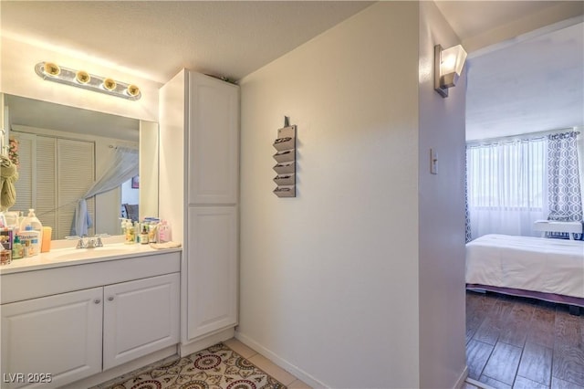 3930 University Center Dr Unit 706, Las Vegas, NV 89119 - ensuite bathroom with vanity and baseboards