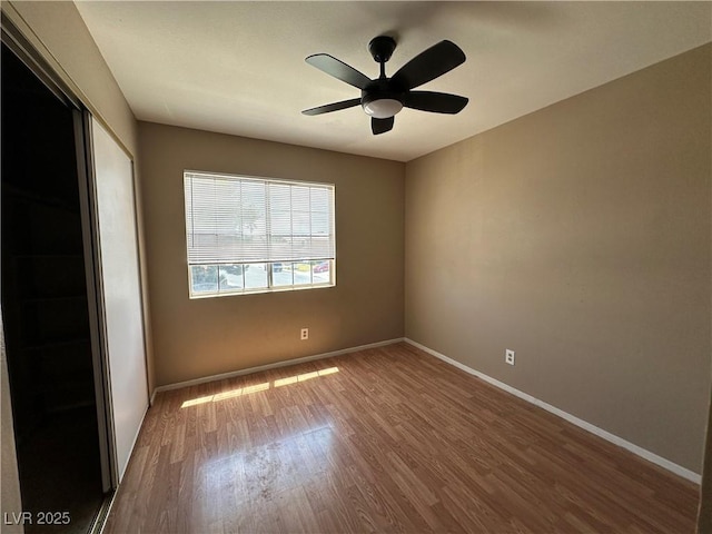 5128 Sandstone Dr, Las Vegas, NV 89142 - unfurnished bedroom featuring wood finished floors, a closet, baseboards, and a ceiling fan