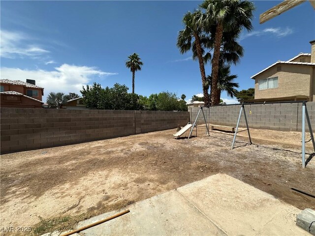 5128 Sandstone Dr, Las Vegas, NV 89142 - fenced backyard featuring a playground