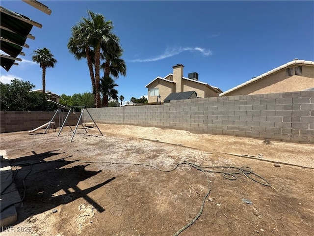 5128 Sandstone Dr, Las Vegas, NV 89142 - fenced backyard with a playground