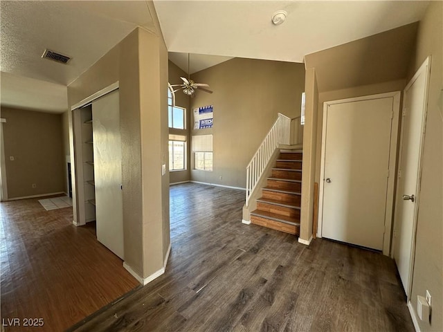 5128 Sandstone Dr, Las Vegas, NV 89142 - stairway with ceiling fan, wood finished floors, baseboards, and a high ceiling